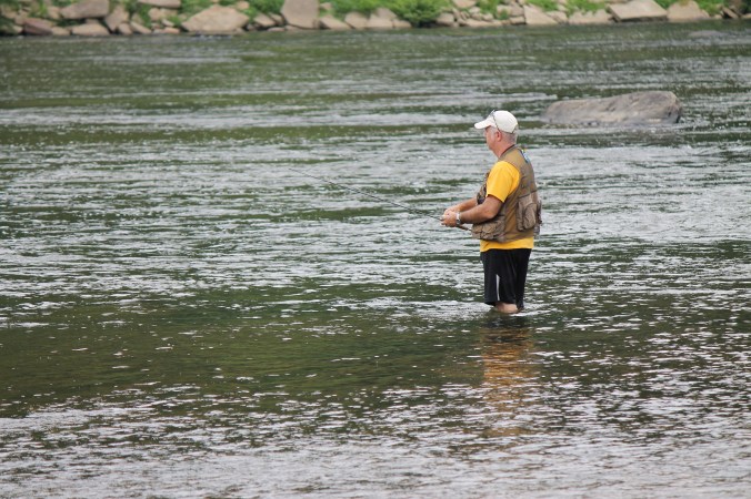 A angler tries his luck near the bridge on Farmers Fish